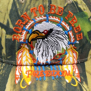 Close-up of bald eagle embroidery on camo baseball cap with Born to Be Free text