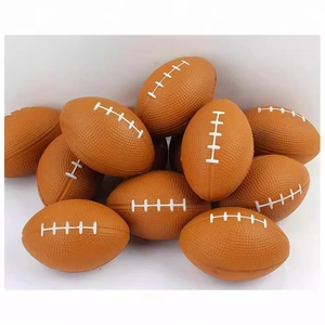 Pile of mini brown PU foam American footballs with white stitching on white backdrop