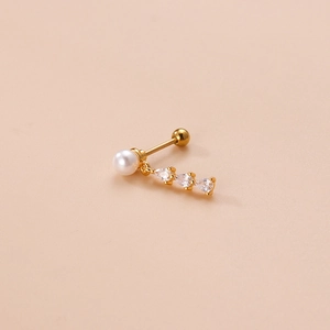 Gold stainless steel stud earring with pearl and three-drop zircon crystals over pink background