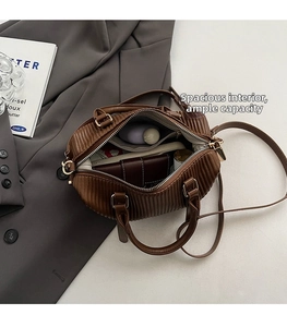 Interior view of brown pleated crossbody bag showing large capacity and internal pocket