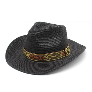 Detail of black straw cowboy hat featuring ethnic geometric pattern hatband and woven texture