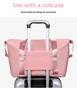 Pink travel bag detail showing the back sleeve fitting over a luggage trolley handle
