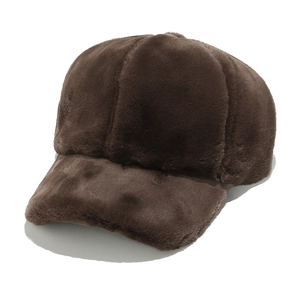 Close-up of thick dark brown faux rabbit fur baseball cap with plush texture and curved brim