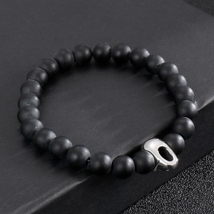 Detail of 316L stainless steel skull charm and matte black beads on men's bracelet