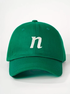 Detail of green cotton canvas baseball cap featuring white embroidered n letter and stitching