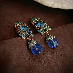 Vintage gold earrings with blue crystals and green rhinestones in Baroque water drop style