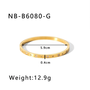 Technical drawing of a gold starburst bangle with 5.9cm diameter and 0.4cm width