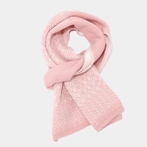 Detail of pink knitted scarf with white polka dots pattern and ribbed cuffs texture