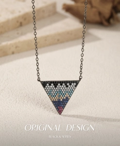 Detail of S925 sterling silver black chain with multi-colored gemstone triangle pendant