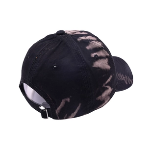Detail view of the silver metal buckle and tie-dye texture on black baseball cap