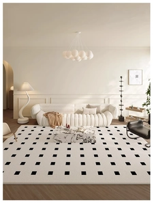 Modern living room setting with black and white checkered carpet and white curved sofa