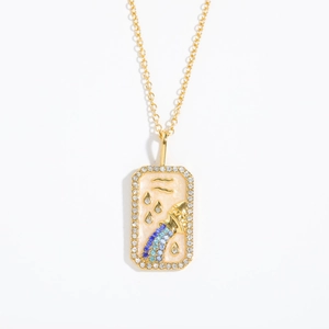 Macro detail of gold Aquarius necklace pendant with colorful gemstones and crystals