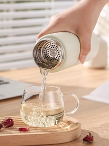 Detail showing SUS 304 stainless steel tea filter of the beige matte insulated bottle