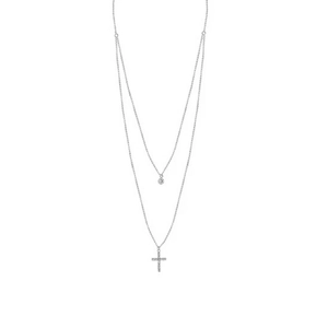 Detail of a layered S925 silver necklace with a sparkling round zircon and cross pendant
