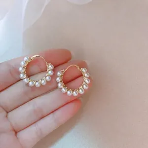 Elegant gold hoop earrings featuring ten circular pearls for a vintage luxury jewelry style