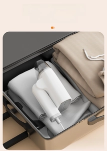 Foldable portable steam iron stored in a travel suitcase for space-saving convenience
