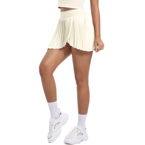Detail view of high-waist cream pleated tennis skirt with irregular hem and wide waistband