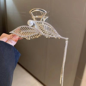 Golden hollow leaf hair claw clip with rhinestones, pearls, and long tassels for women