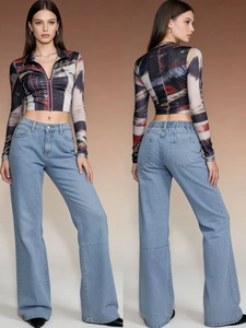 Close-up of high-waisted wide-leg denim jeans paired with a printed zip-up crop top