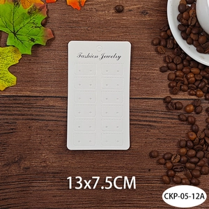 White cardboard jewelry display card 13x7.5cm with multi-hole design on wood background