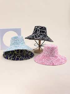 Collection of four wide brim sun hats in various colors with artistic texture on display