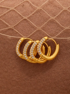 Detail view of gold hoop earrings with multi-row white zircon micro-pave setting