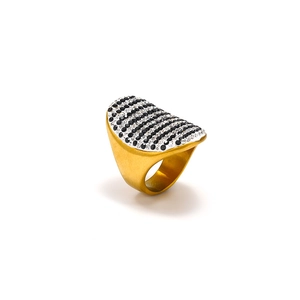 Detailed close-up of golden stainless steel ring with black and white rhinestone stripes