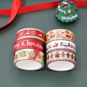 Detailed view of six Christmas washi tape rolls with Santa and reindeer patterns