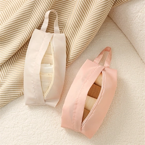 Portable travel organizers for underwear and socks in light pink and beige fiber fabric