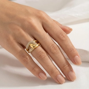 Close-up of elegant double-layered gold titanium ring with pavé diamonds on a model