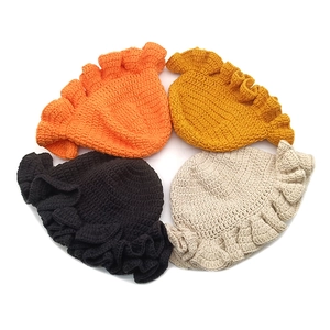 Winter crochet bucket hats with ruffle edges in orange, yellow, black and beige