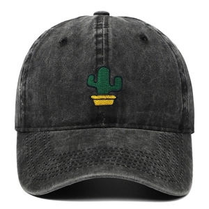 Close-up of green cactus embroidery on a washed dark gray cotton baseball cap
