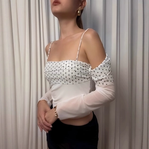 Detail view of white polka dot tube top with transparent mesh long sleeves for women