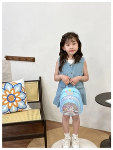 Front view of light blue sequin kids backpack with crown handle and unicorn rainbow print