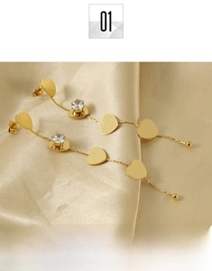 Detail of 18K gold-plated titanium steel heart tassel earrings with sparkling zircon stones