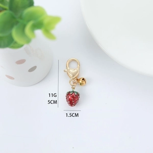 Creative strawberry keychain with gold bell pendant, 5cm length and 11g lightweight design