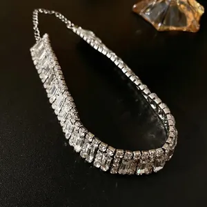 Luxury geometric choker necklace with clear crystals on a textured black background