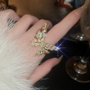 Detail of gold plated butterfly ring featuring zircon crystals and pearl on hand