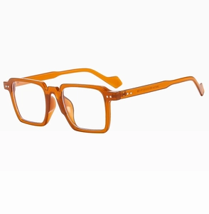 Detail of retro amber square frame sunglasses with metallic rivets and acetate texture