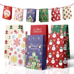 Assorted paper Christmas gift bags featuring colorful snowman and gingerbread man prints