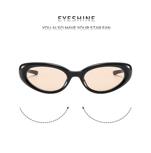 Detail of vintage cat-eye cycling sunglasses with glossy black frames and peach lenses