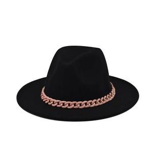 Detail of a black wool fedora featuring a stylish pink resin chain band decoration