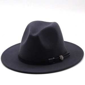 Close-up of the silver floral metal buckle on a dark grey wool felt fedora hat