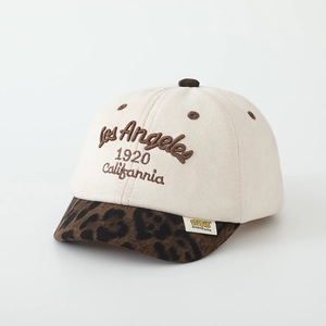 Detailed close-up of beige suede kid baseball cap with leopard print and Los Angeles embroidery