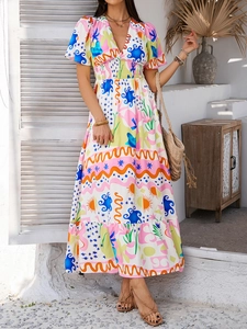 Close-up of bohemian V-neck dress featuring vibrant abstract floral patterns and elastic waist
