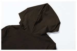 Detailed close-up of hooded neckline on brushed stretch fabric yoga set in dark brown
