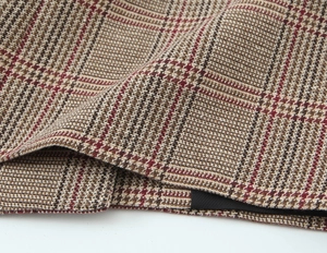 Close-up detail of premium houndstooth woven fabric in brown and beige tones