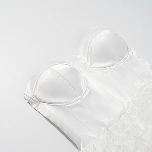 Detail of white satin corset top featuring 3D tulle拼接 layers and boning structure