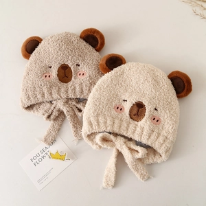 Cute teddy bear plush baby hat with earflaps and chin straps for winter warmth