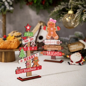 Close-up of wooden Christmas tree decor with Merry Christmas text on a warm festive desk